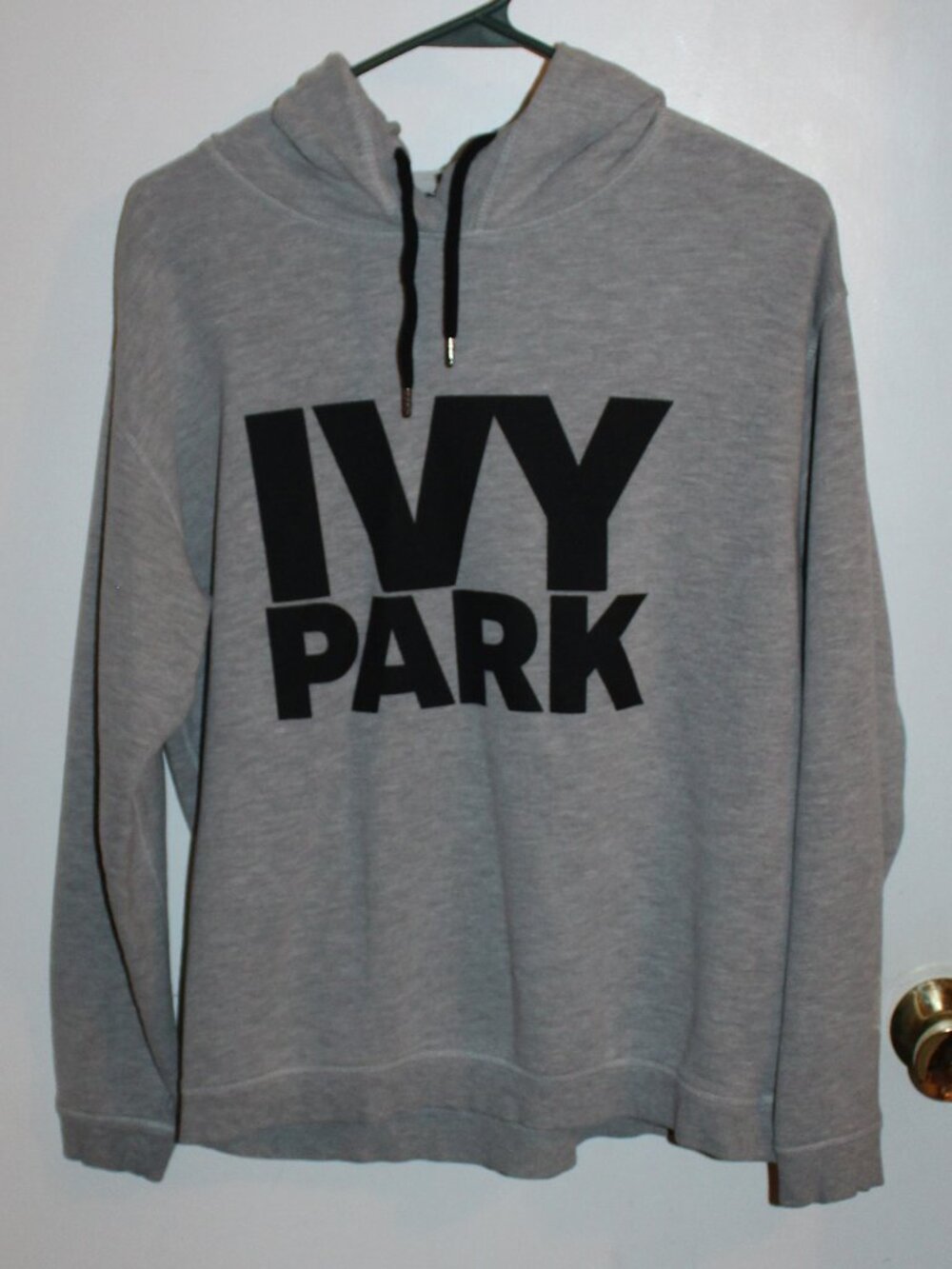 Ivy Park hoodie - heather gray color with a bold black logo graphic